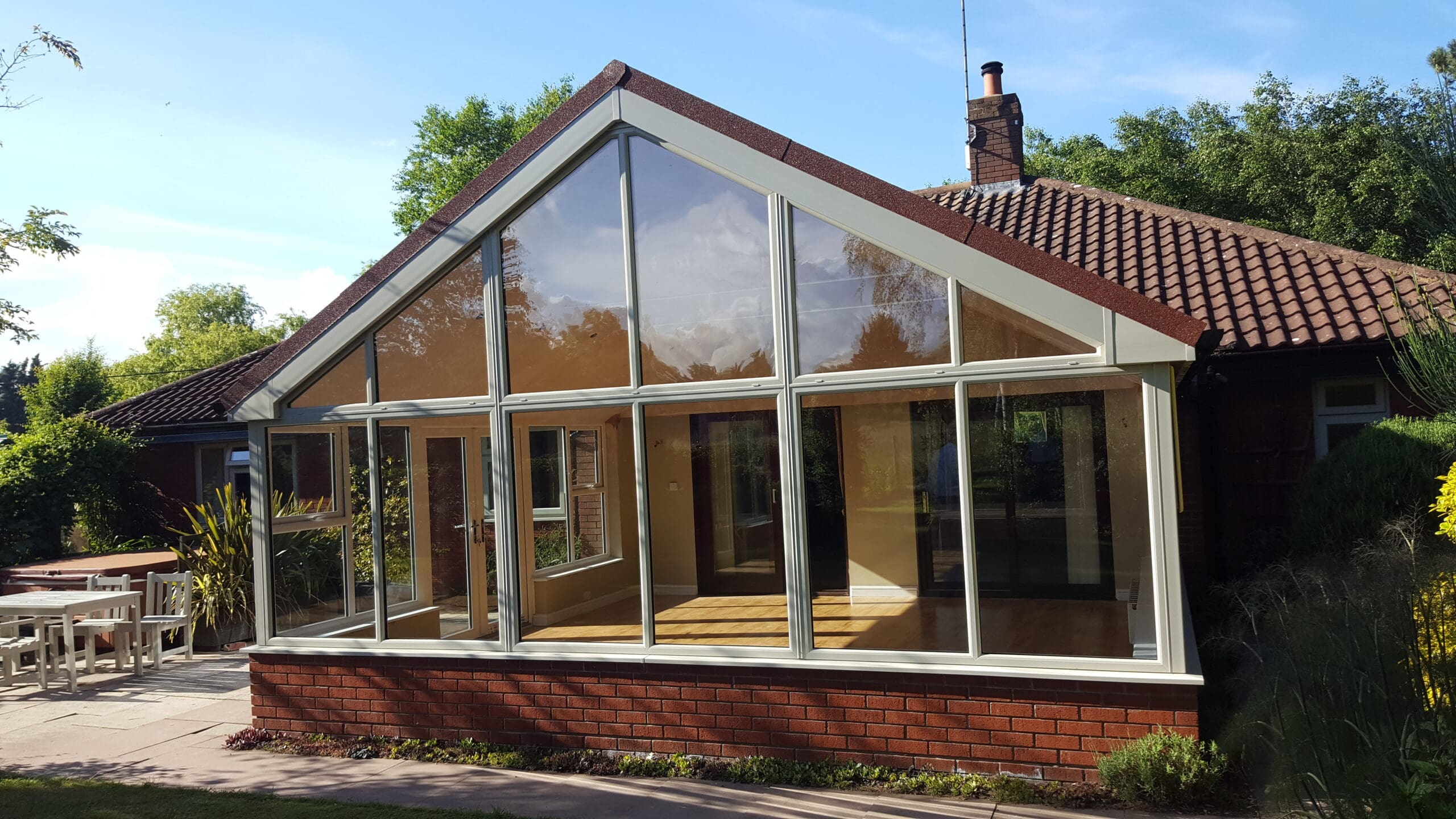 EW | Insulated Conservatory Company | Insulated Conservatory Company Gable end conservatory with a fully glazed gable and brick base on a bungalow