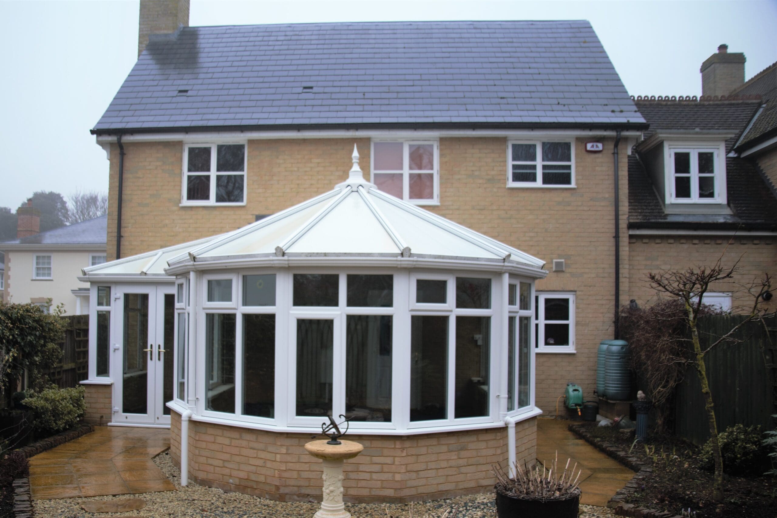 6 Conservatory with a replacement dark solid roof on a yellow brick base