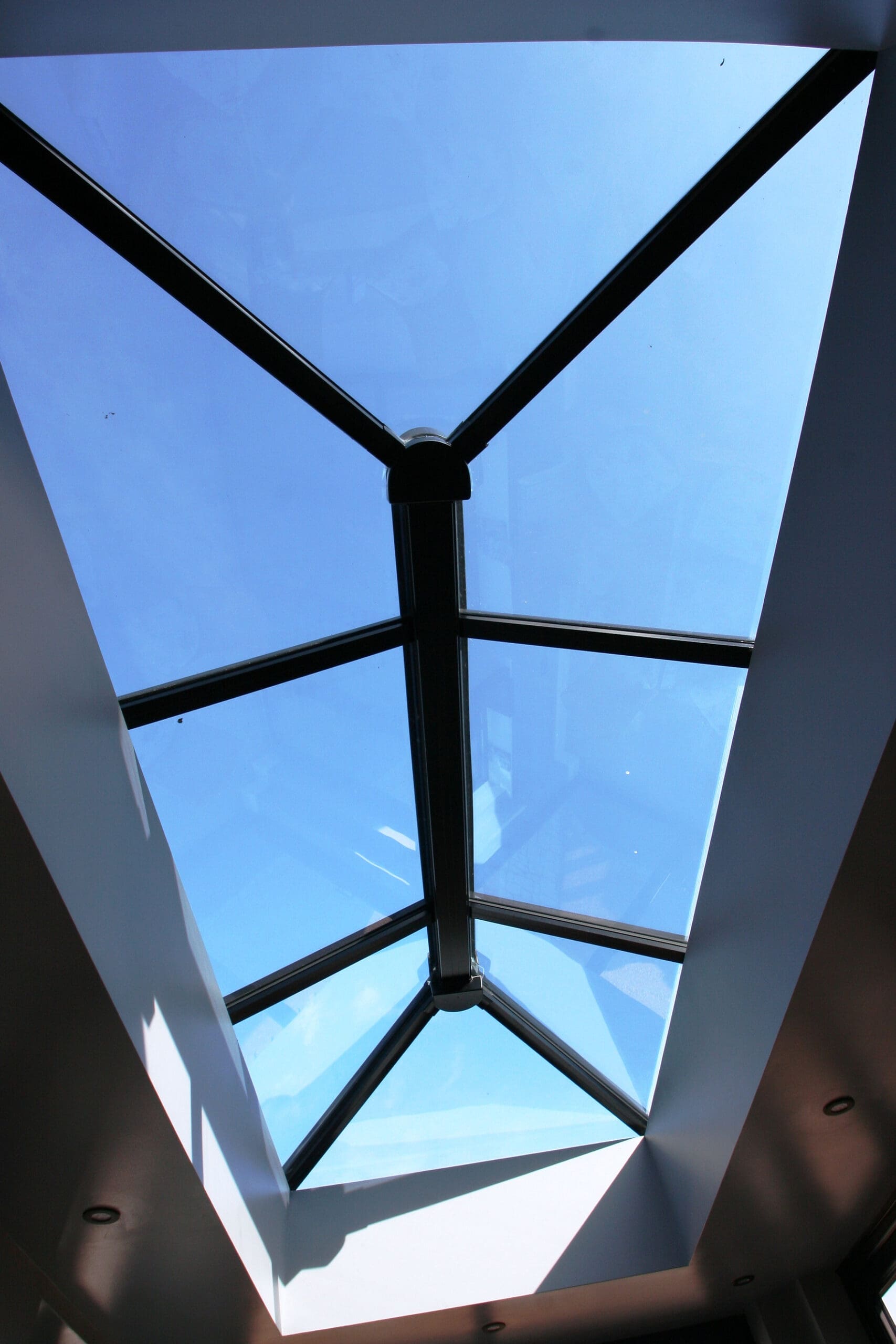 84d924_c7806eadc9cc49a88d1b7d708833db48~mv2_d_2336_3504_s_2 | Insulated Conservatory Company | Insulated Conservatory Company Roof lantern viewed from below against a blue sky