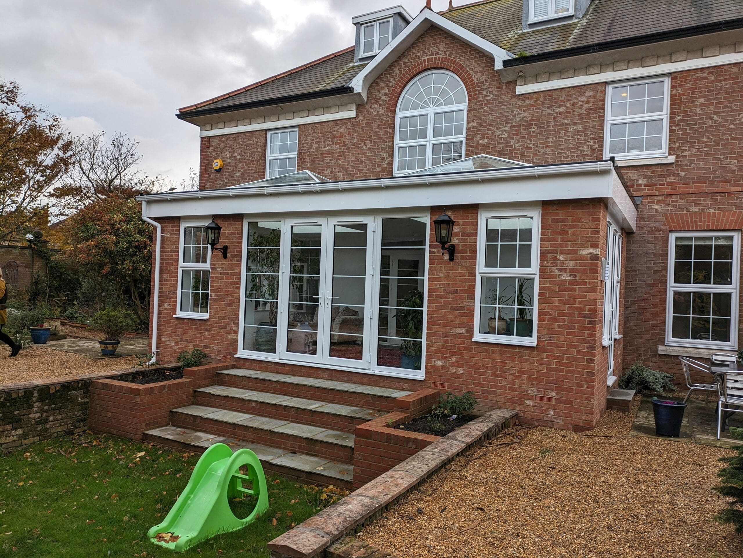 PXL_20231109_133929485 | Insulated Conservatory Company | Insulated Conservatory Company White sunroom extension with a lantern roof on a red brick house